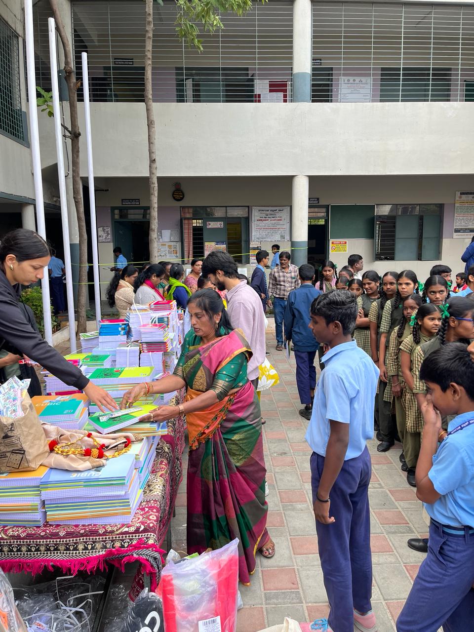 Students lining up for distribution of notebooks and stationery
