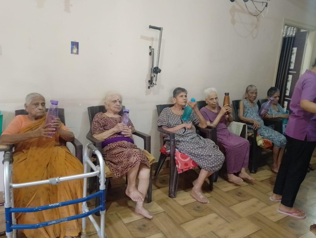 A volunteer companion sits with an elder