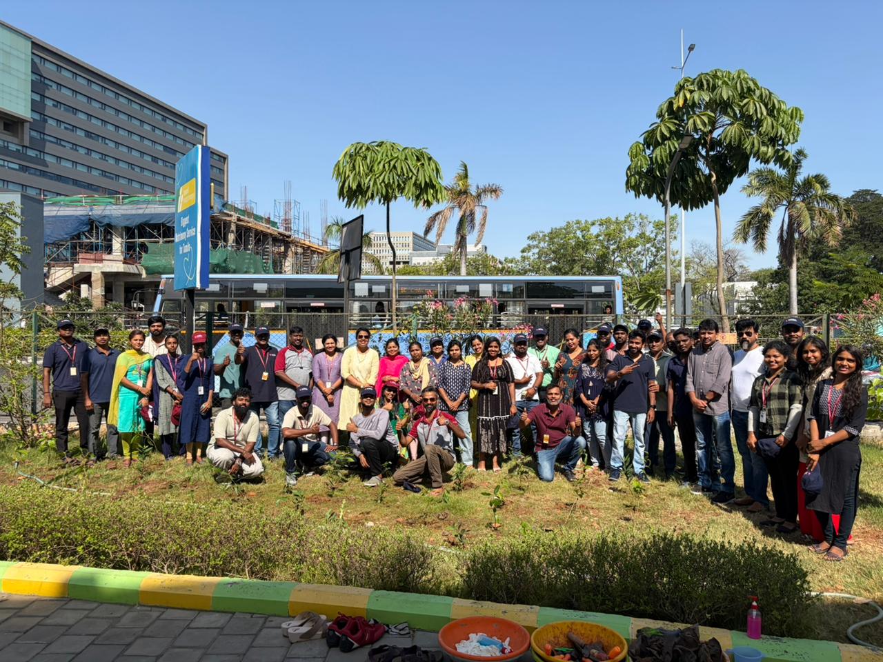 A large group of volunteers posing for a group photo outdoors.