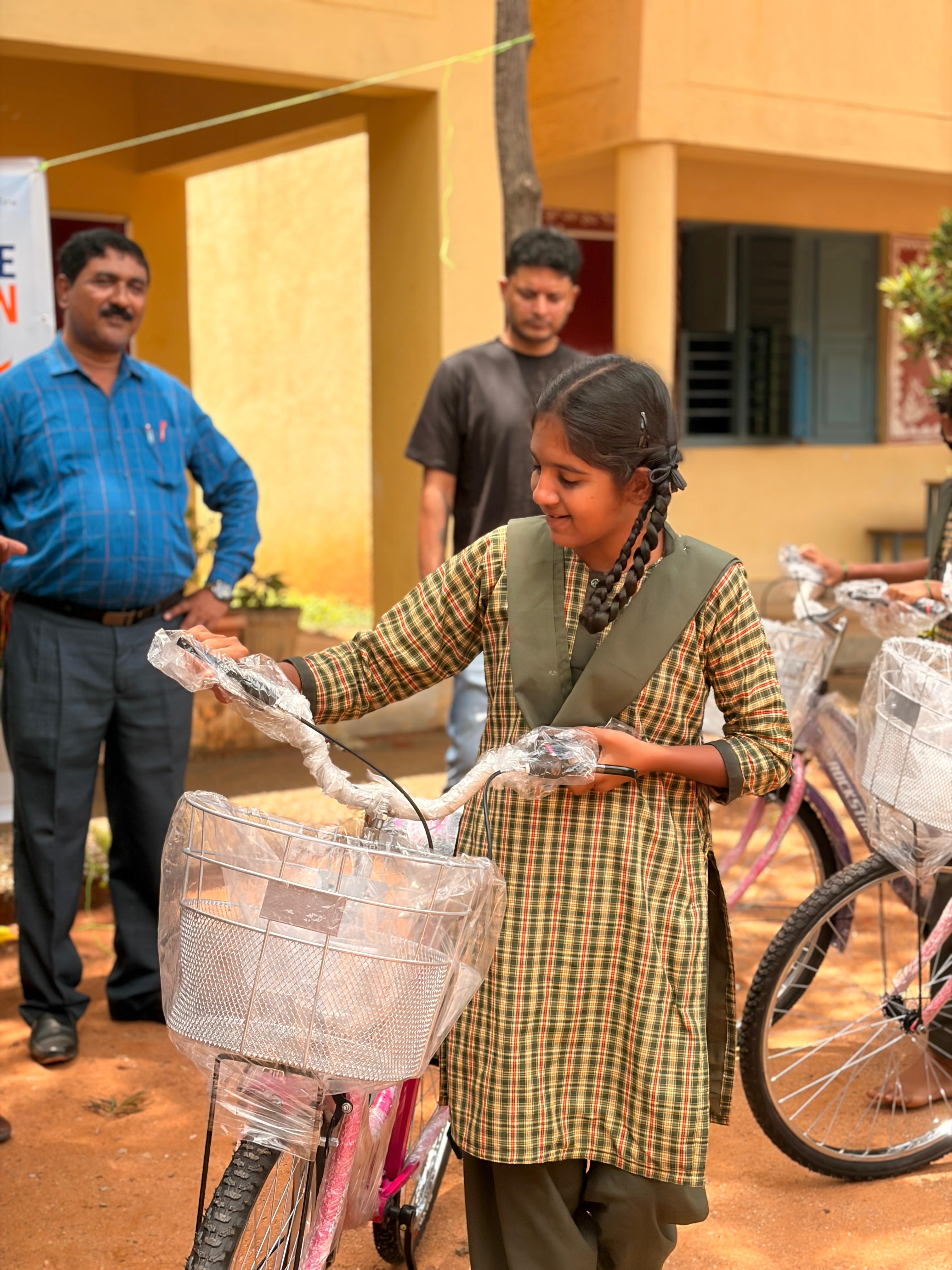 A student unwrapping the handlebars of her new bicycle